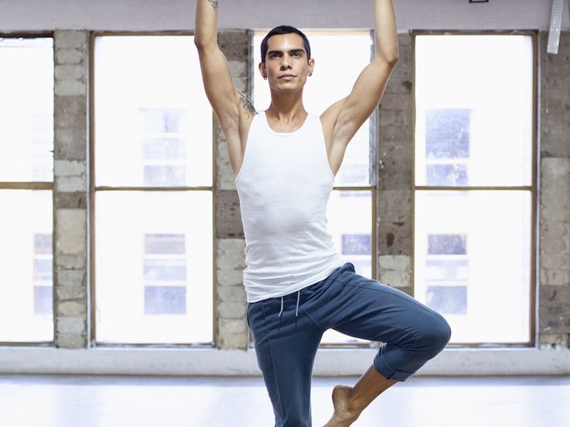 Athlete performing a focused strength movement in a bright studio