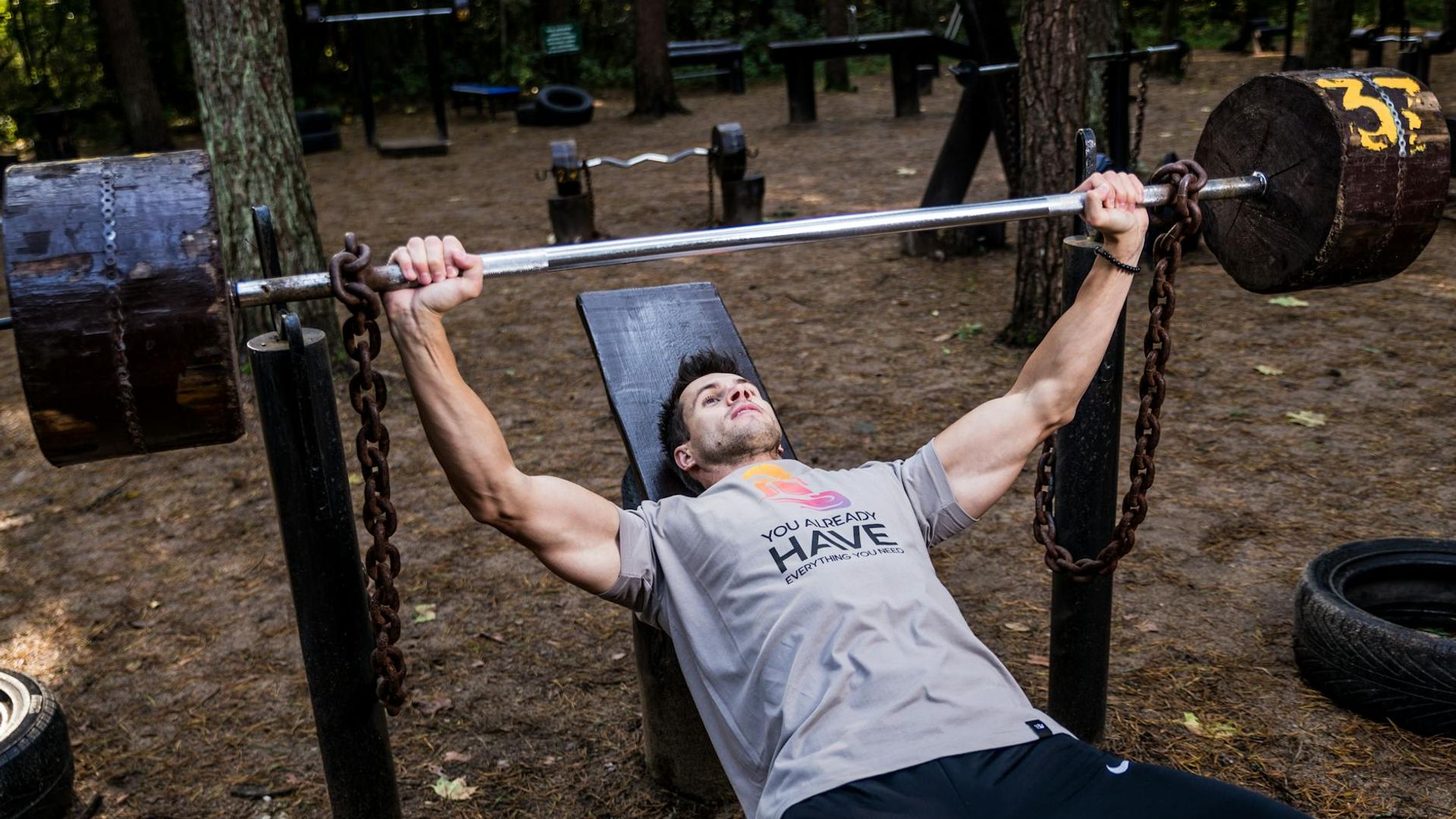 Strong man exercising with heavy weights in a professional gym